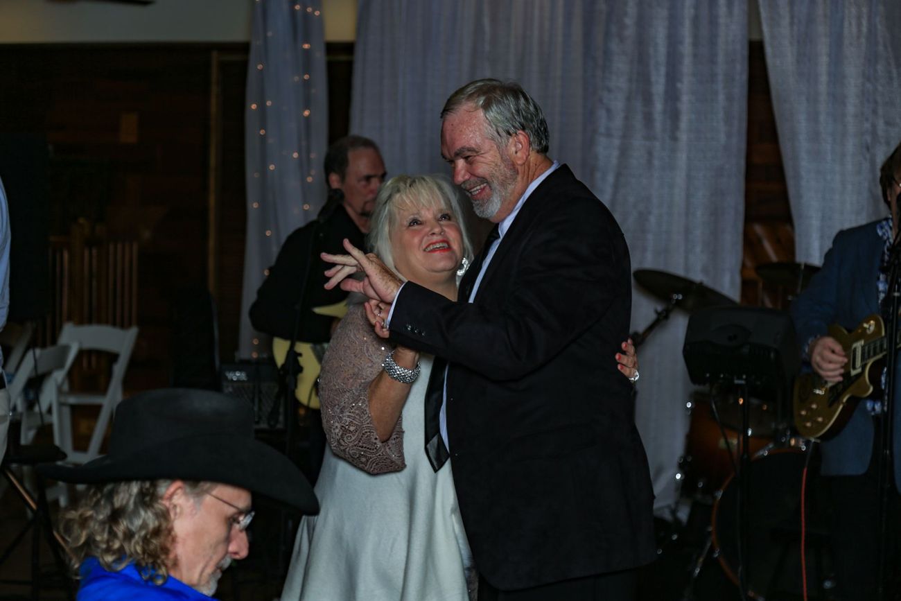 An older couple dancing in front of the band